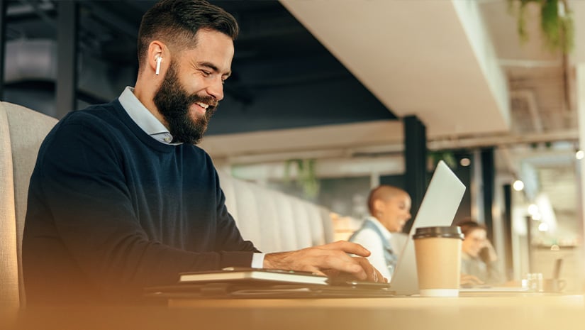 Cheerful businessman working on his laptop