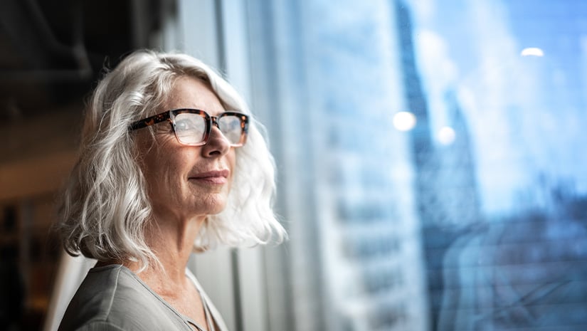 Mature businesswoman looking out of window