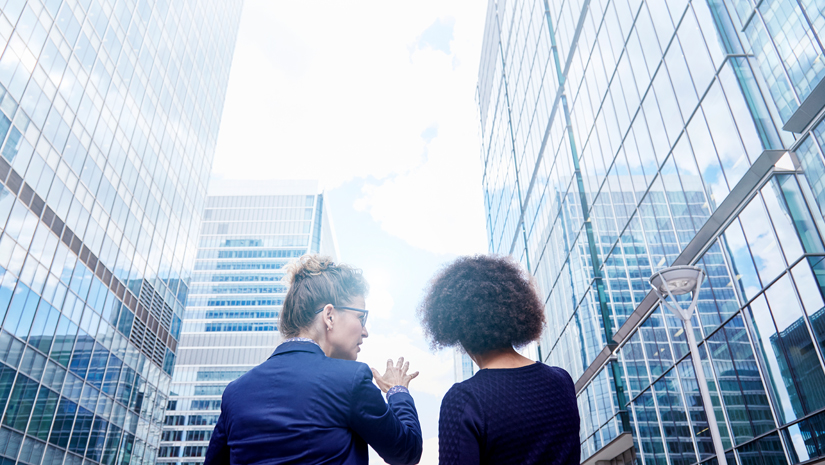 Real estate women looking a buildings in a city