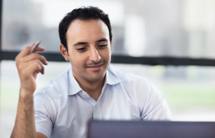 man looking at computer smile