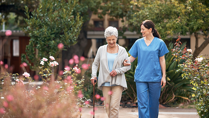 caregiver and her patient out for a walk in the garden