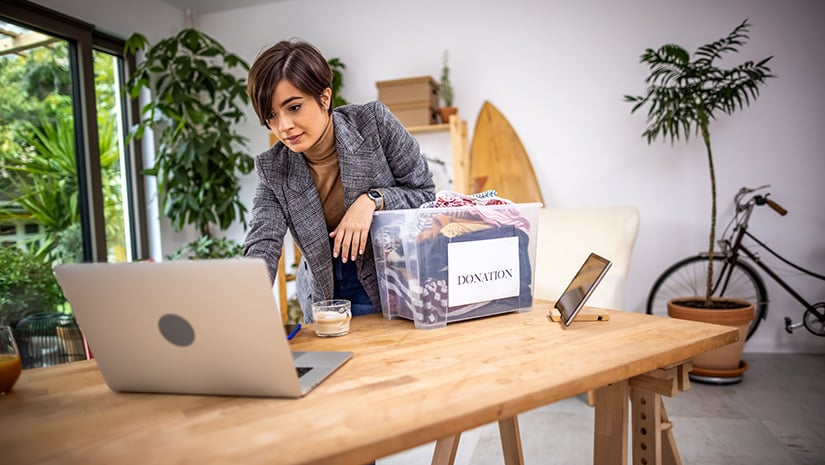 Volunteer at home office preparing clothes for the donation