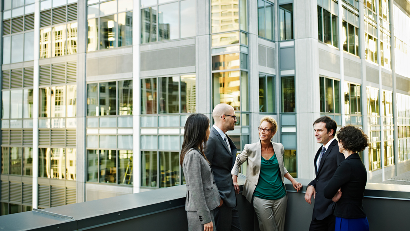 Realtors having meeting on the rooftop of a building.